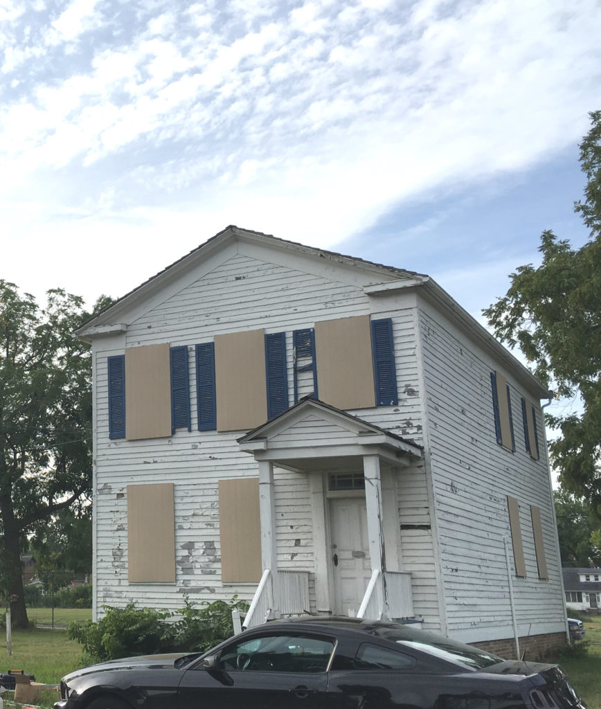 Grant Home in 2018 with boarded windows and peeling paint.